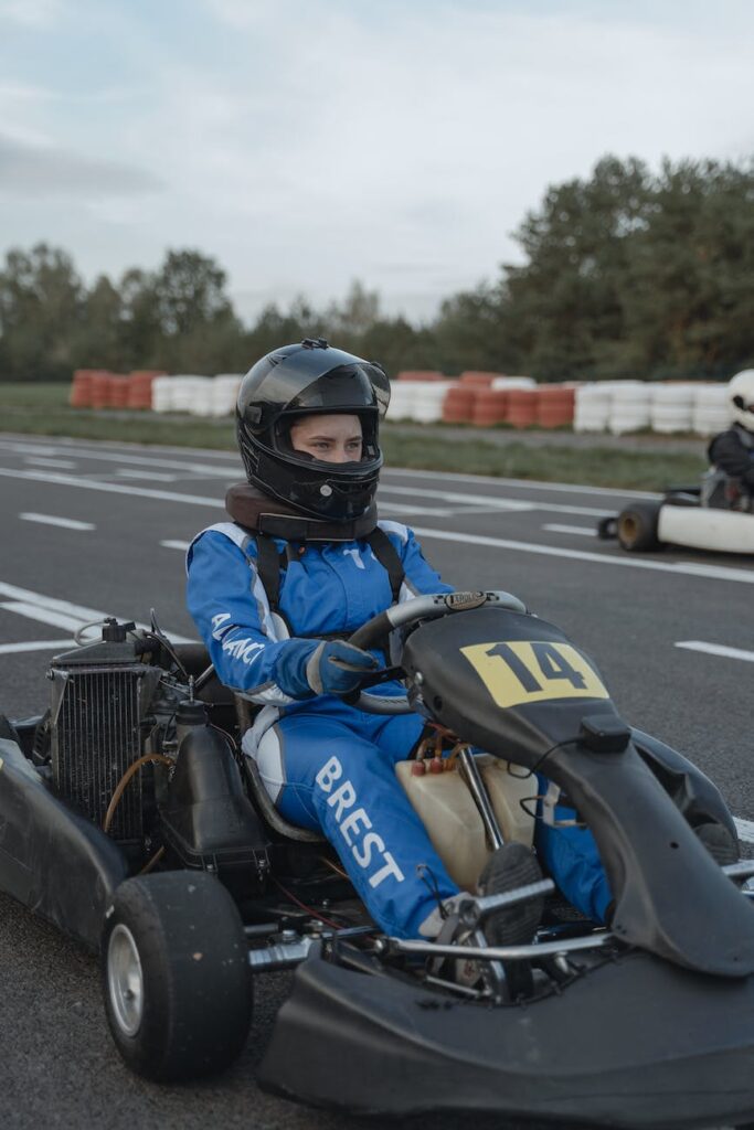 go kart racer wearing protective gears while riding a car